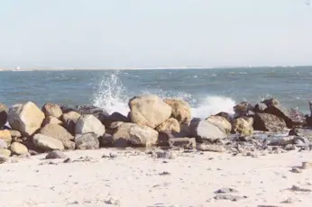 Rock placed against the eroding inlet shore