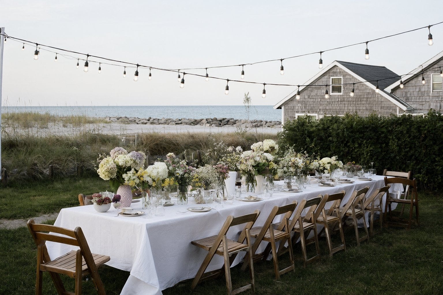 Illustration: a long outdoor table under string lights at a summer garden party